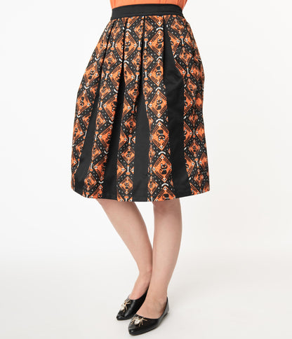 This is a Unique Vintage Halloween swing skirt that has black cats, bats and skulls with orange print and the model is wearing an orange shirt and black shoes with spiders.